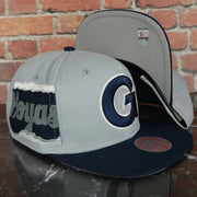 Georgetown Hoyas NCAA Jumbotron "Hoyas" Ripped Wordmark side patch Grey Bottom Grey/Navy Snapback hat | Mitchell and Ness Two Tone Snap Cap