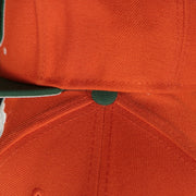 green button on the Miami Hurricanes NCAA Jumbotron "U Miami" Ripped Wordmark side patch Grey Bottom Orange/Green Snapback hat | Mitchell and Ness Two Tone Snap Cap