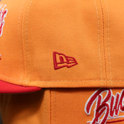 The New Era logo on the Tampa Bay Buccaneers Team Script Gray Bottom 9Fifty Snapback | Orange And Red Snap Cap