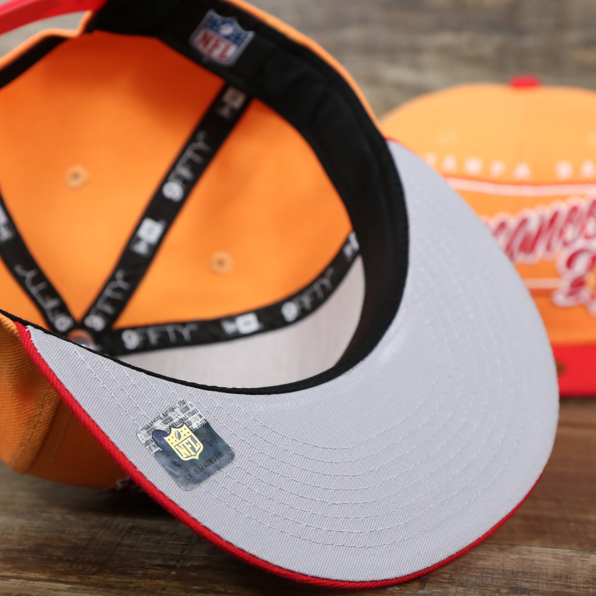 The Gray undervisor on the Tampa Bay Buccaneers Team Script Gray Bottom 9Fifty Snapback | Orange And Red Snap Cap