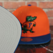 grey under visor on the Florida Gators NCAA Jumbotron "Florida" Ripped Wordmark side patch Grey Bottom Yellow/Navy Snapback hat | Mitchell and Ness Two Tone Snap Cap