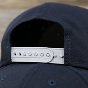 Close up of the back logo on the New York Yankees "Team Script" College Bar Style 9Fifty Snapback Hat | Vintage Logo, Navy/Grey