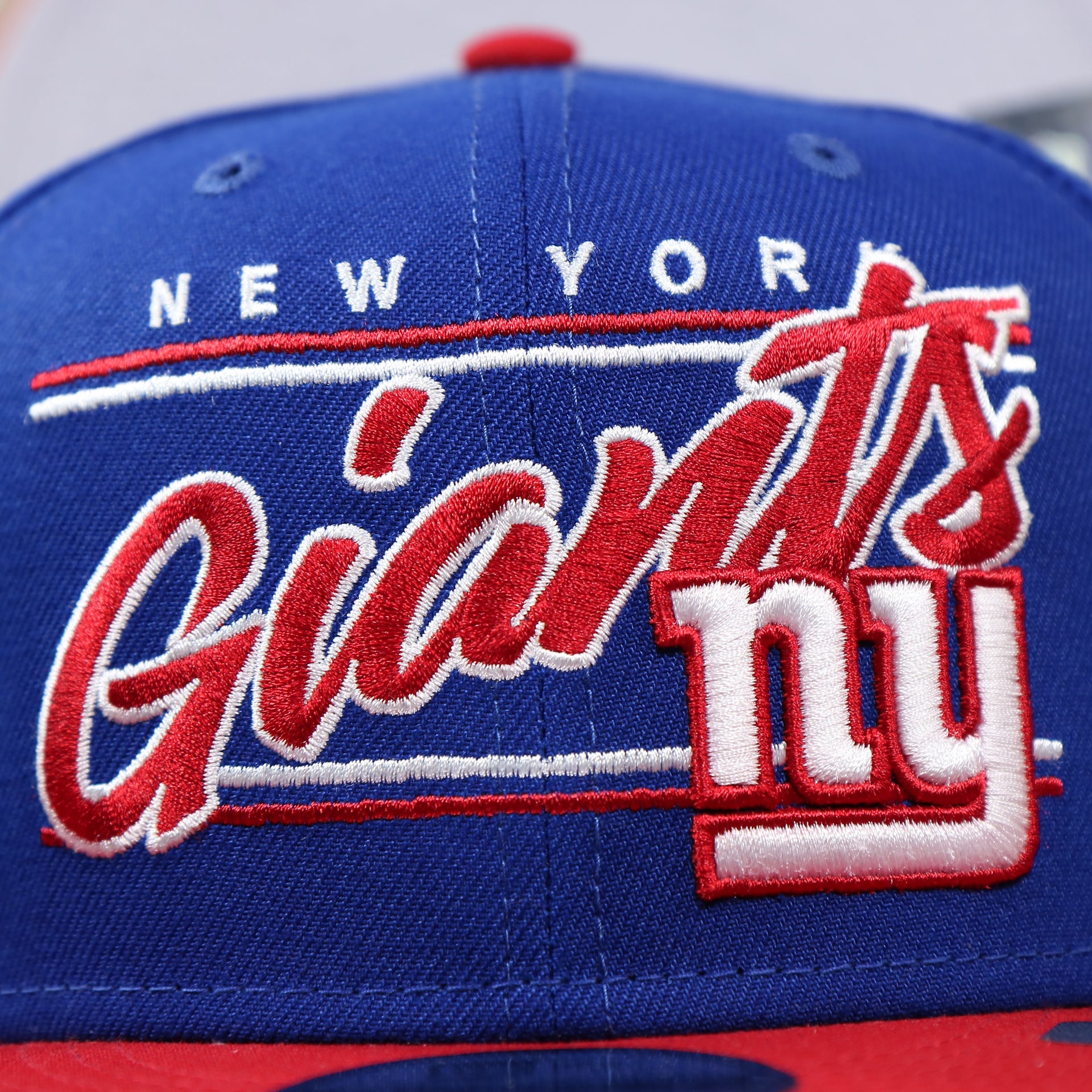 The New York Giants Team Script on the New York Giants Team Script Gray Bottom 9Fifty Snapback | Royal Blue And Red Snap Cap