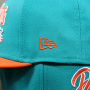 The New Era Logo on  the Miami Dolphins Team Script Gray Bottom 9Fifty Snapback | Aqua and Orange Snap Cap