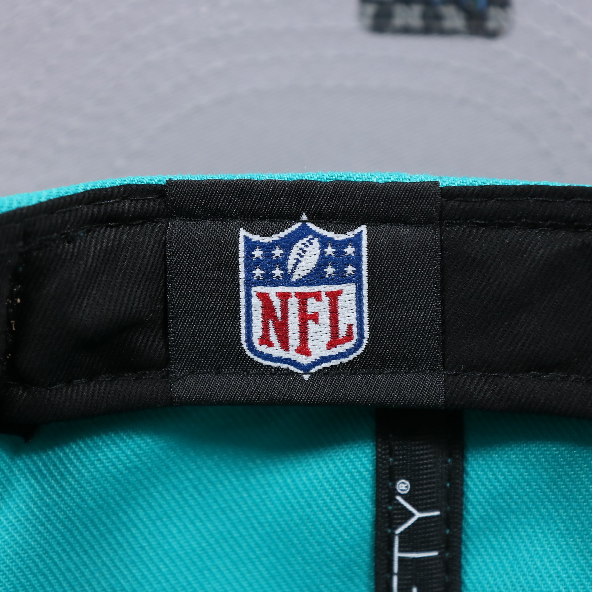The NFL Tag on the Miami Dolphins Team Script Gray Bottom 9Fifty Snapback | Aqua and Orange Snap Cap