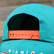 The Orange Adjustable Strap on the Miami Dolphins Team Script Gray Bottom 9Fifty Snapback | Aqua and Orange Snap Cap