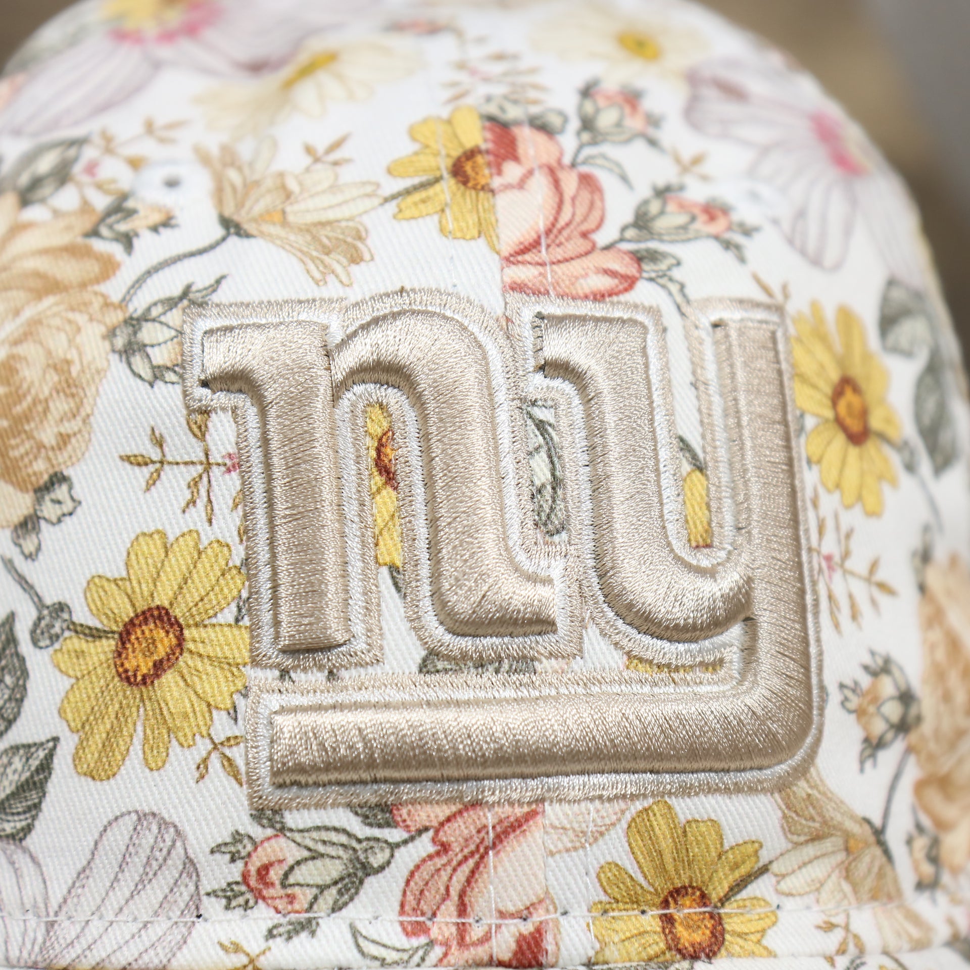 Close up of the logo on the New York Giants All Over Sunflower Rose Floral Fall Flower Bloom Print Ladies' Ball Cap