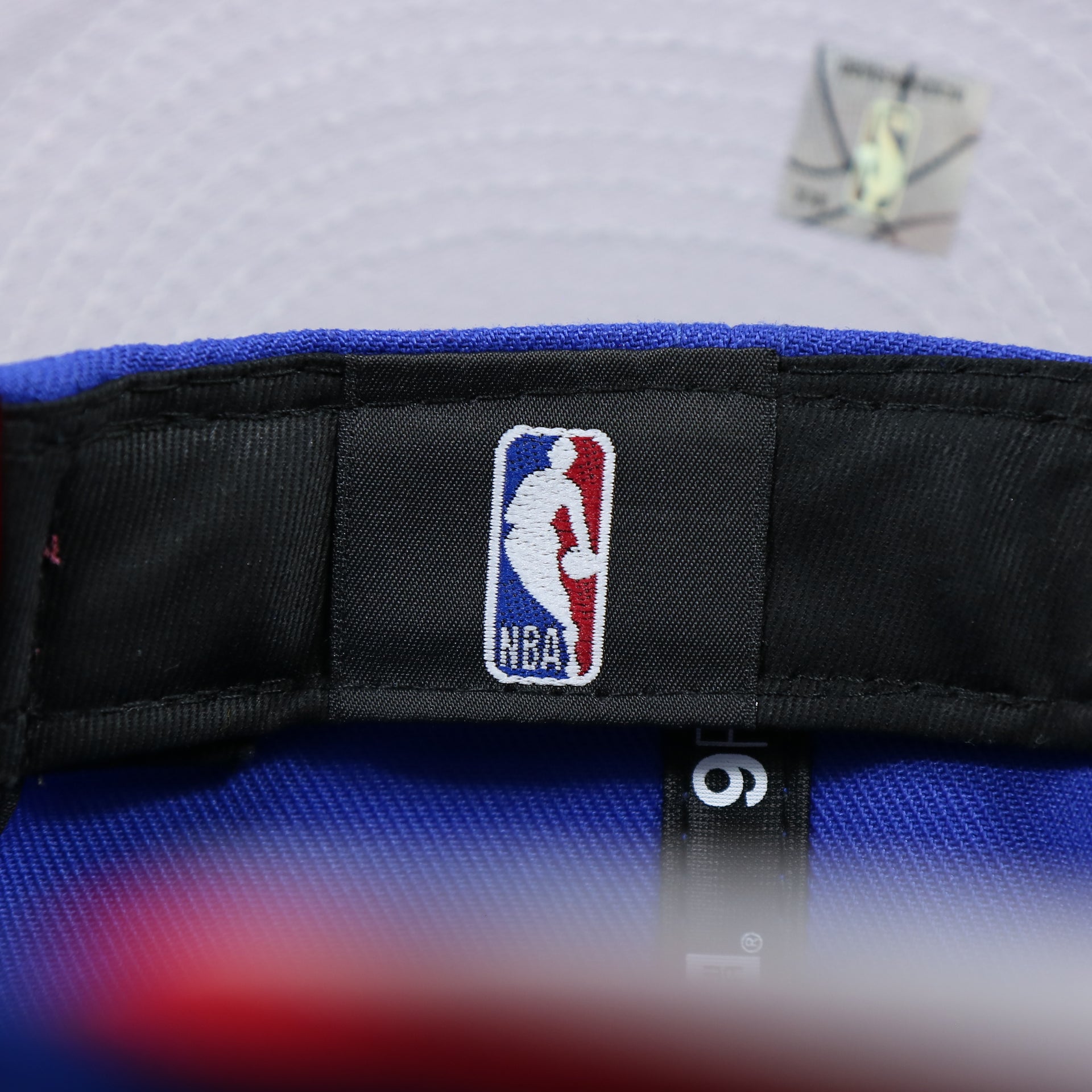The NBA Tag on the Philadelphia 76ers Team Script Gray Bottom 9Fifty Snapback | Royal Blue And Red Snap Cap