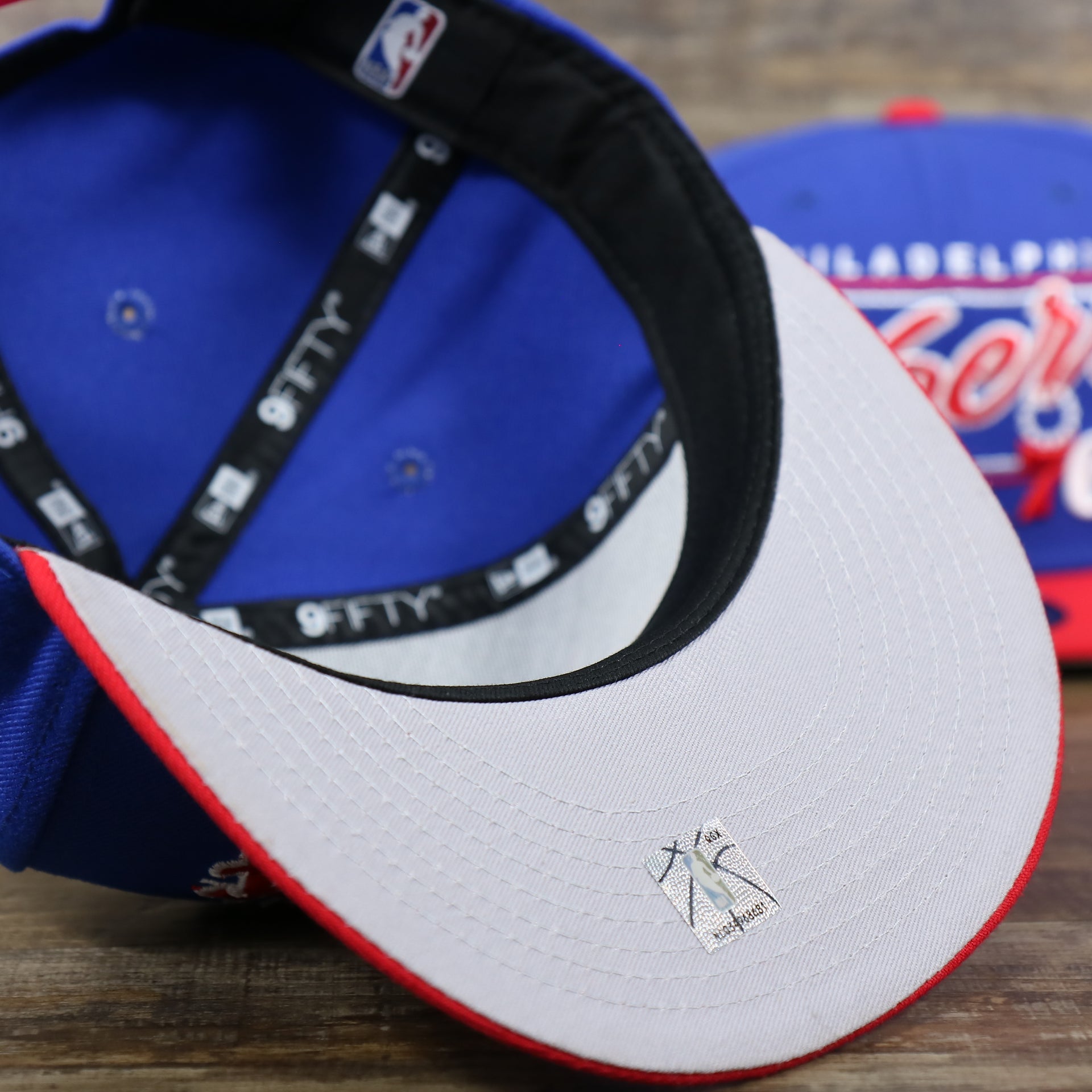 The Gray undervisor on the Philadelphia 76ers Team Script Gray Bottom 9Fifty Snapback | Royal Blue And Red Snap Cap