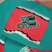 spurs ripped logo on the San Antonio Spurs Hardwood Classics Jumbotron Spurs Ripped Logo side patch Grey Bottom Teal/Red Snapback hat | Mitchell and Ness Two Tone Snap Cap