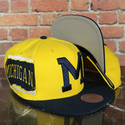 Michigan Wolverines NCAA Jumbotron "Michigan" Ripped Wordmark side patch Grey Bottom Yellow/Navy Snapback hat | Mitchell and Ness Two Tone Snap Cap