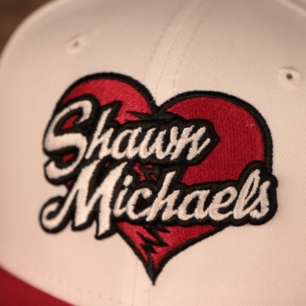 shawn michaels logo on the Shawn Michaels Heart Break Kid White 9Fifty White Gray Bottom Snapback