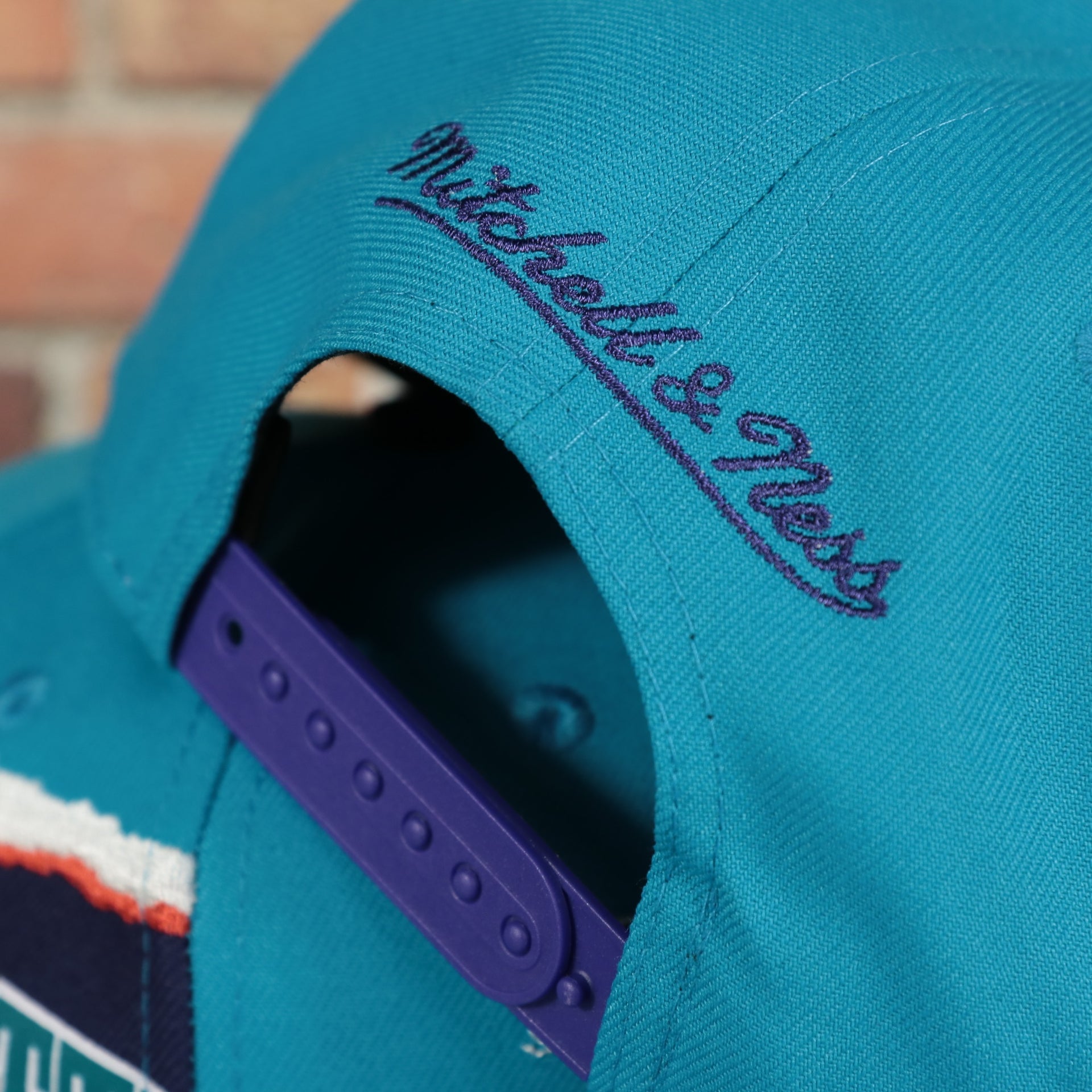 mitchell and ness logo on the Charlotte Hornets Hardwood Classics Jumbotron "Charlotte" Ripped Wordmark side patch Grey Bottom Teal/Purple Snapback hat | Mitchell and Ness Two Tone Snap Cap