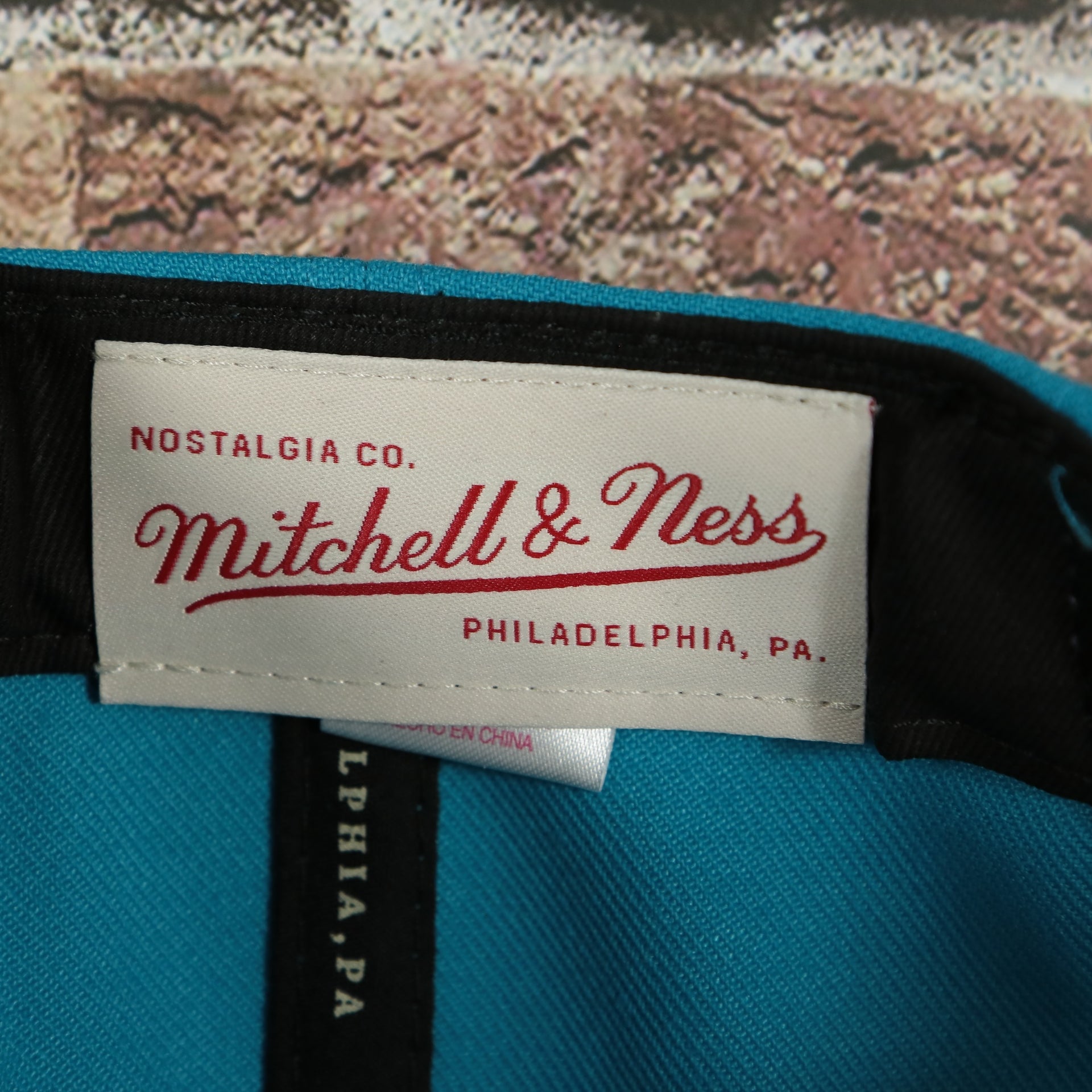 mitchell and ness label on the Charlotte Hornets Hardwood Classics Jumbotron "Charlotte" Ripped Wordmark side patch Grey Bottom Teal/Purple Snapback hat | Mitchell and Ness Two Tone Snap Cap
