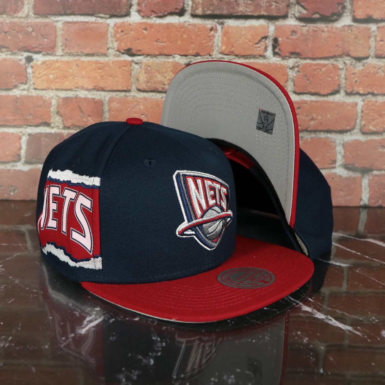 New Jersey Nets Hardwood Classics Jumbotron "Nets" Ripped Wordmark side patch Grey Bottom Navy/Red Snapback hat | Mitchell and Ness Two Tone Snap Cap