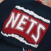 nets ripped wordmark on the New Jersey Nets Hardwood Classics Jumbotron "Nets" Ripped Wordmark side patch Grey Bottom Navy/Red Snapback hat | Mitchell and Ness Two Tone Snap Cap