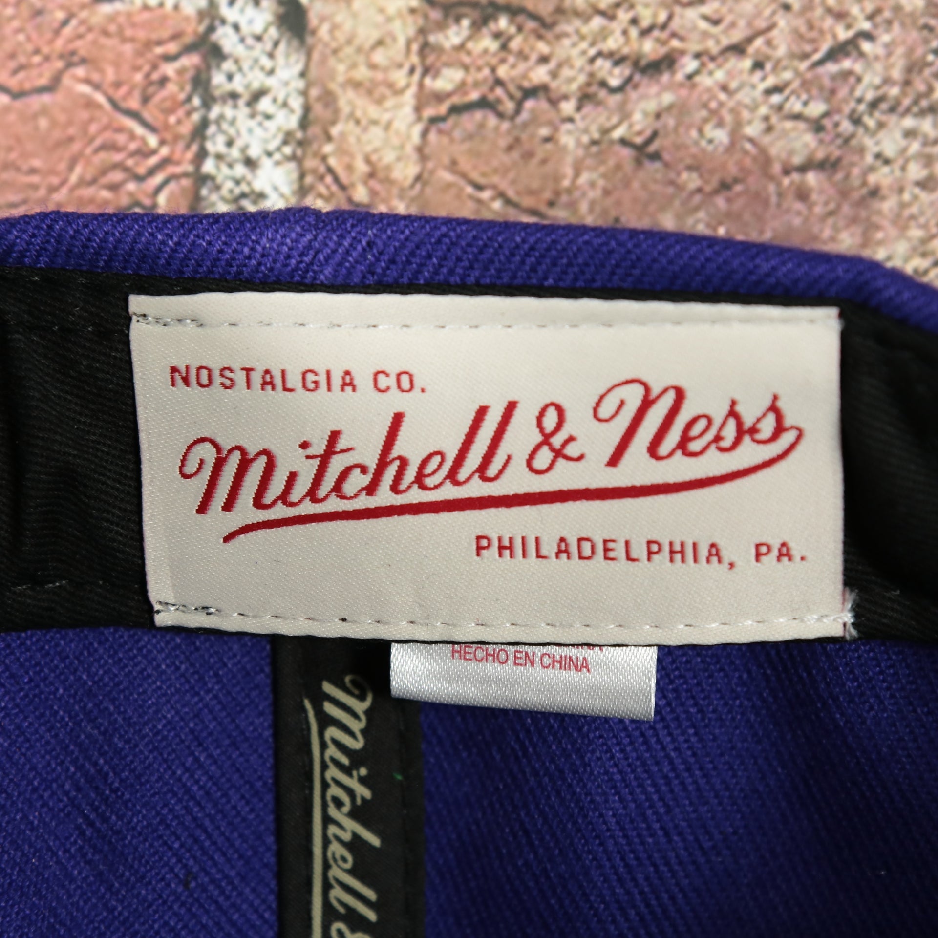 mitchell and ness label on the Toronto Raptors Retroline Logo Outline Vintage Snapback Hat | Mitchell and Ness Raptors Snap Cap