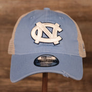 front of the North Carolina Tar Heels Carolina Blue 9Twenty Distressed Adjustable Trucker Dad Hat