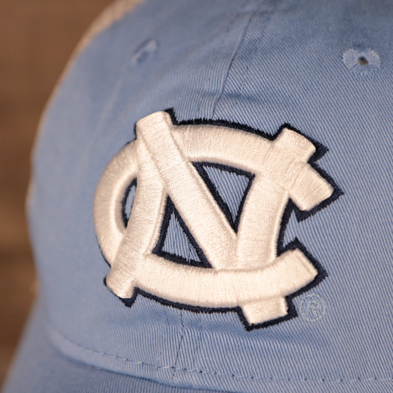 NC logo on the front of the North Carolina Tar Heels Carolina Blue 9Twenty Distressed Adjustable Trucker Dad Hat