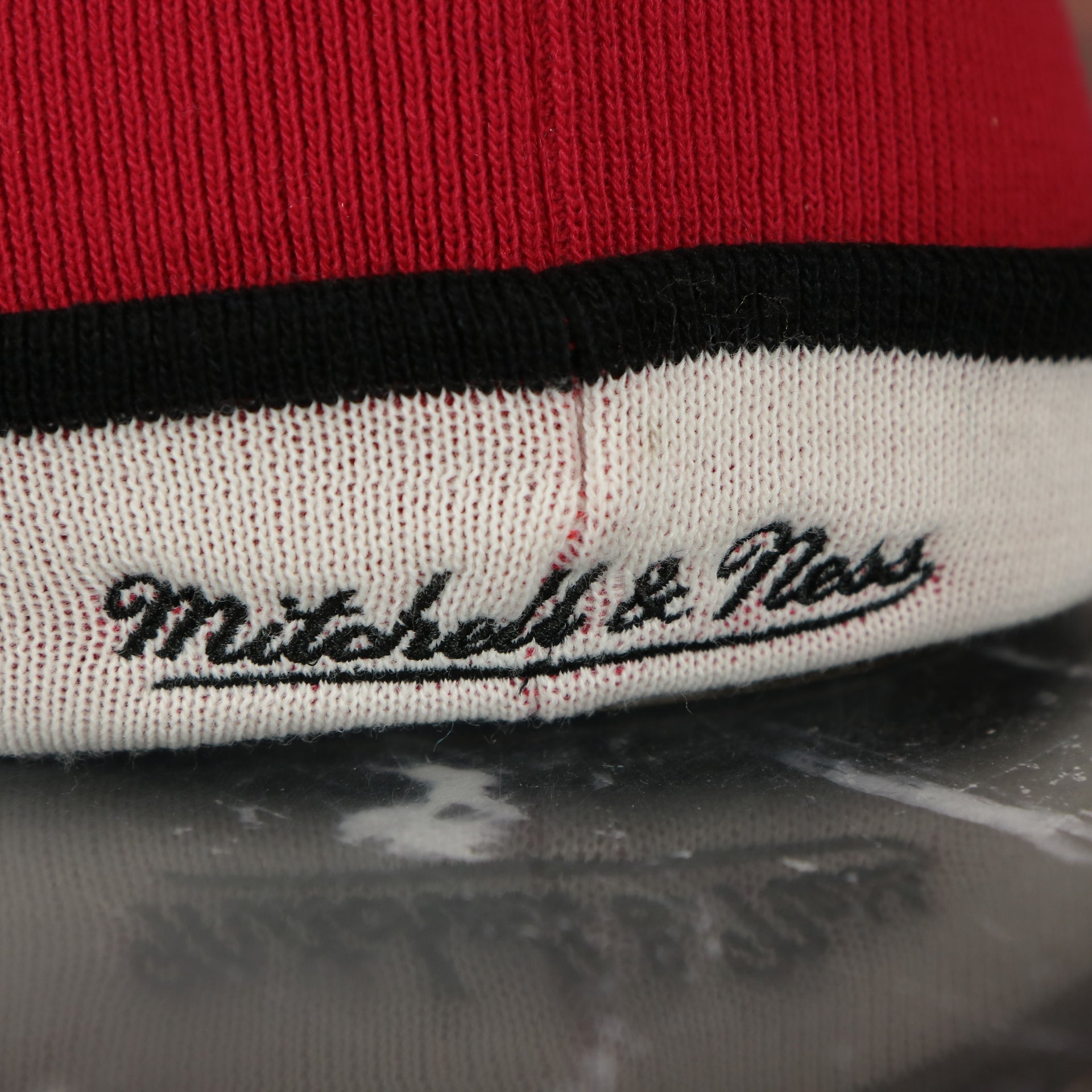 mitchell and ness logo on the Miami Heat Split Pom Pom Winter Beanie With Heat Pin | Red Winter Beanie