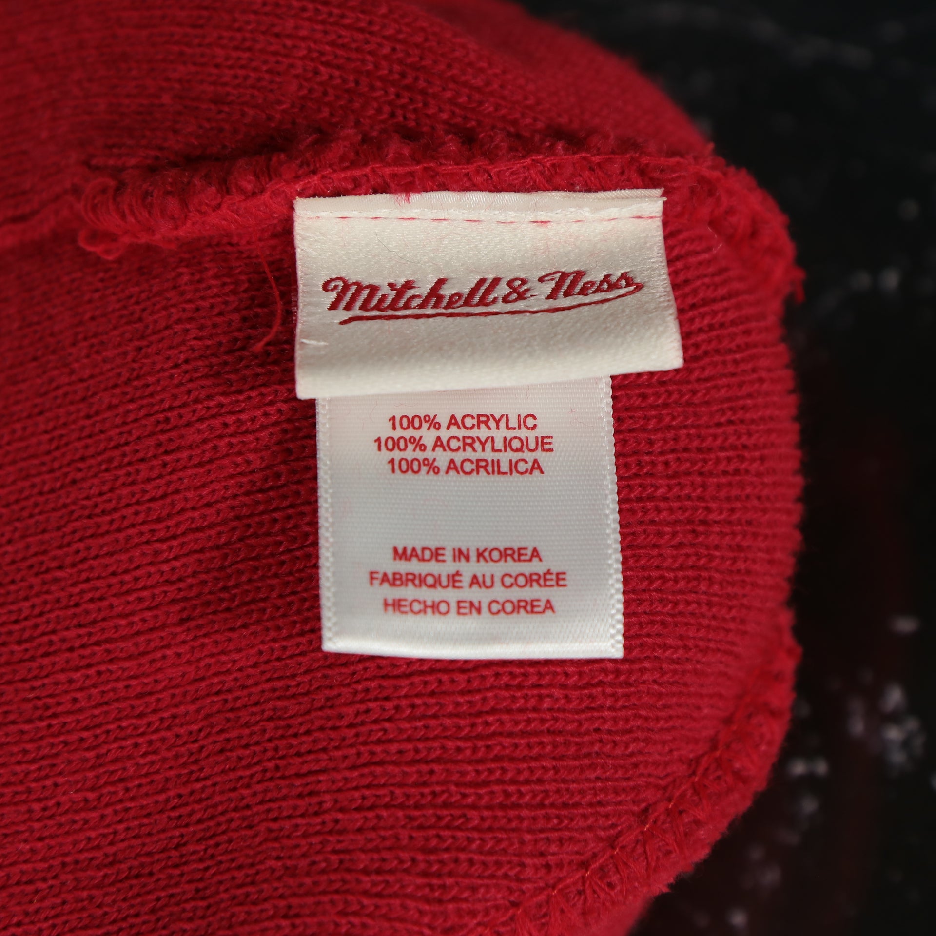 mitchell and ness label on the Miami Heat Split Pom Pom Winter Beanie With Heat Pin | Red Winter Beanie