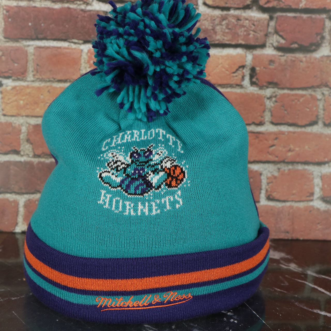 hornets logo on the Charlotte Hornets Retro Logo Two Sided Cuffed Winter Beanie | Purple And Light Blue Winter Beanie