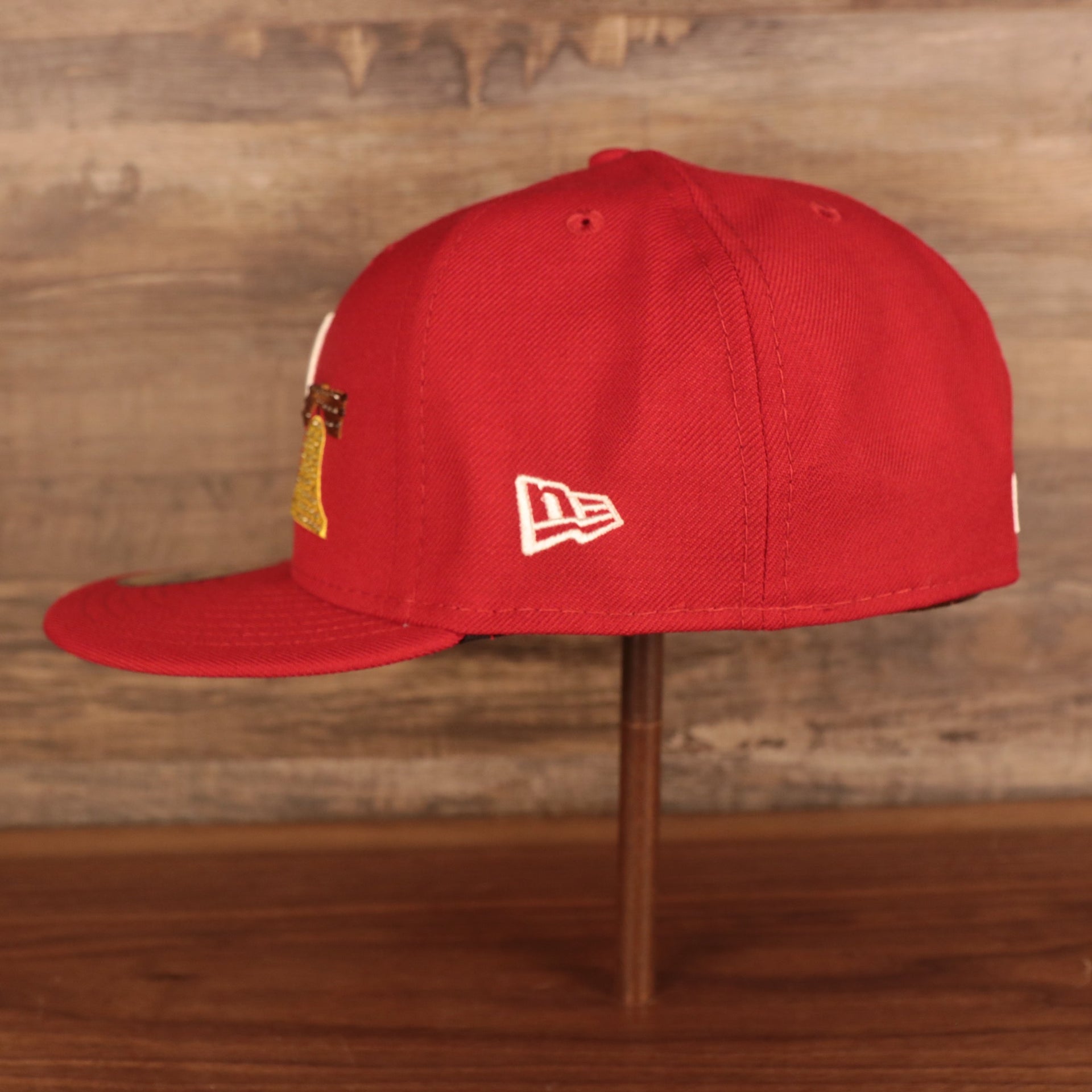 Wearer's left of the Philadelphia Phillies Iced Out Side Patch Bell 1776 Gray Bottom 59Fifty Fitted Cap