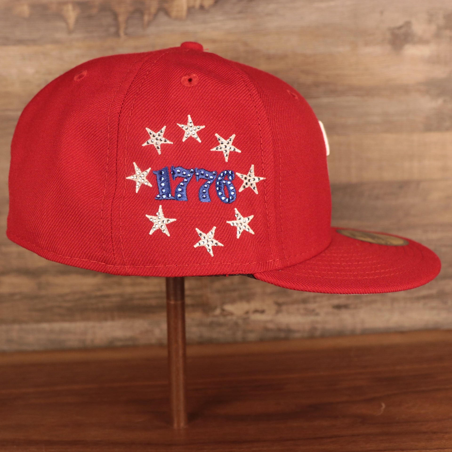 Wearer's right of the Philadelphia Phillies Iced Out Side Patch Bell 1776 Gray Bottom 59Fifty Fitted Cap