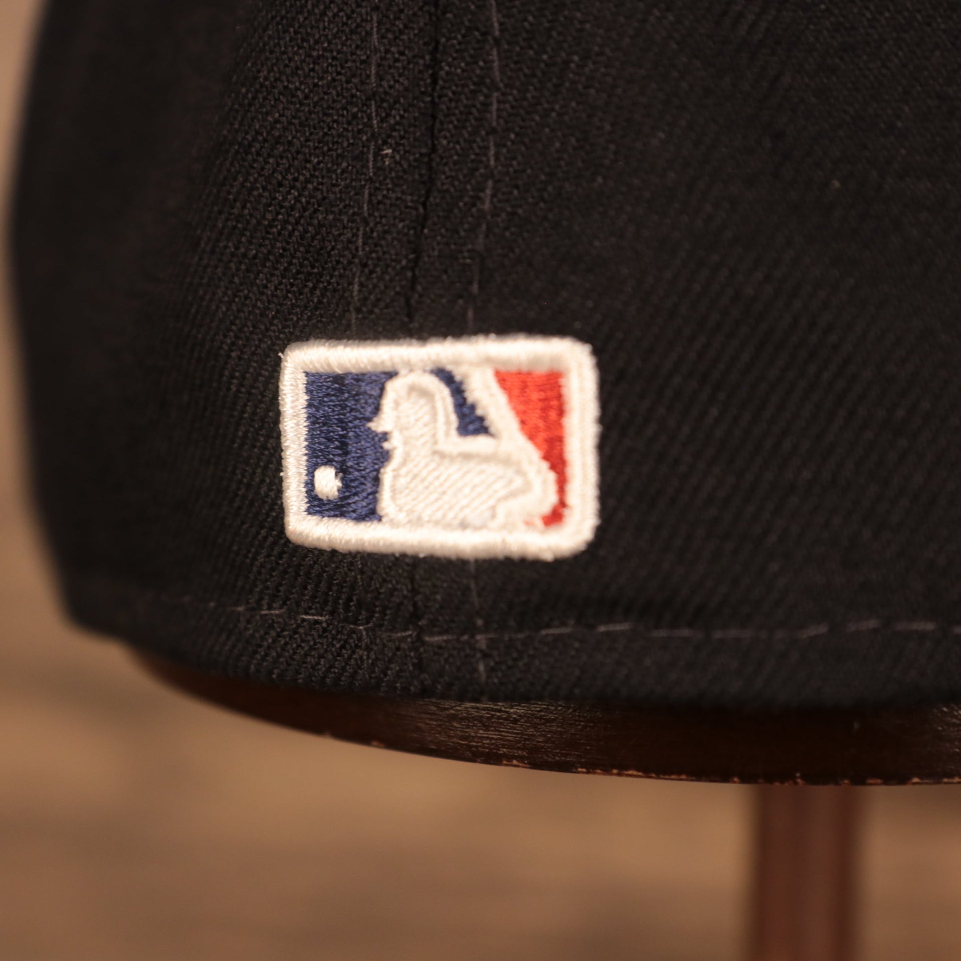 Close up of the MLB logo on the New York Yankees Multi-Color Paisley Bandana Under Brim 59Fifty Fitted Cap