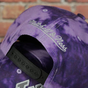 mitchell and ness logo on the Los Angeles Lakers Galaxy Purple Reflective Script Mitchell and Ness Snapback Hat
