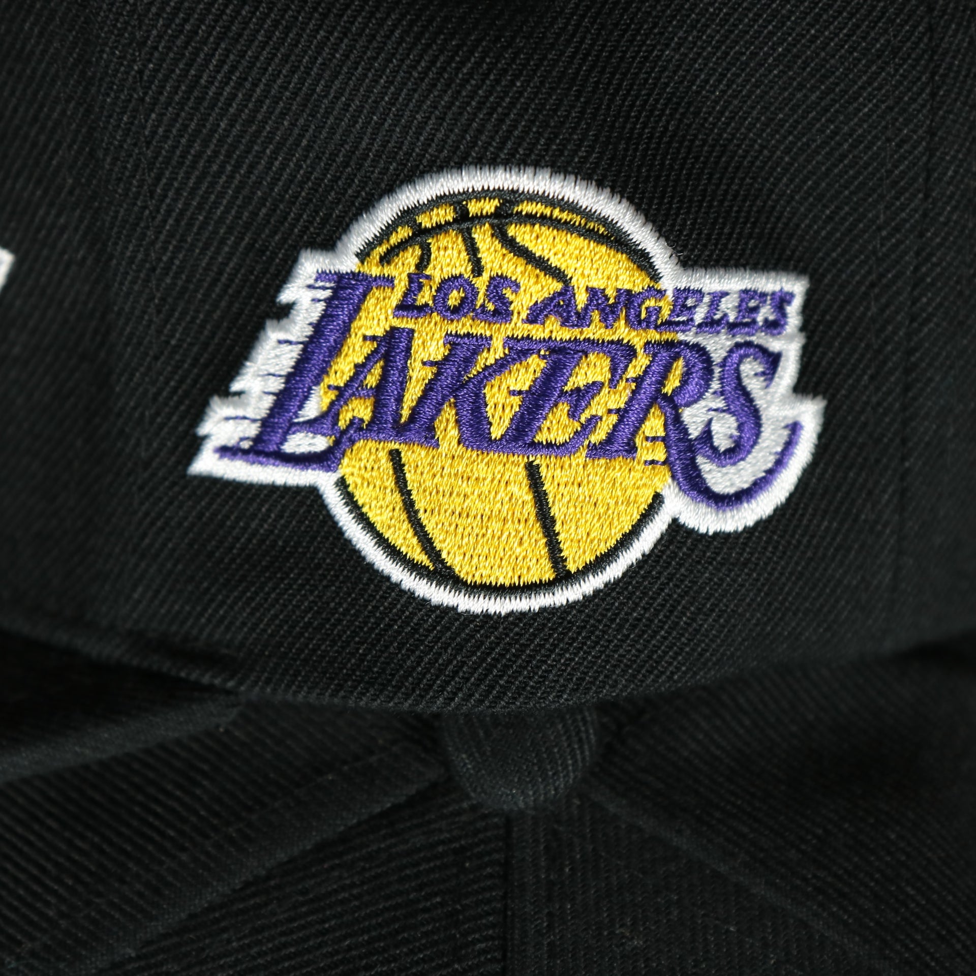 lakers logo on the Los Angeles Lakers Vintage Retro NBA Team Script 2.0 Mitchell and Ness Snapback Hat | Black