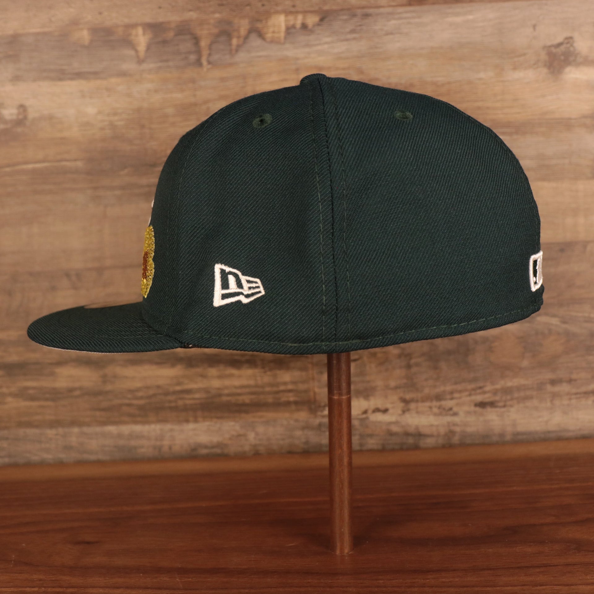 Wearer's left side of the Oakland Athletics Iced Out Side Patch Flower Oakland Bridge Gray Bottom 59Fifty Fitted Cap