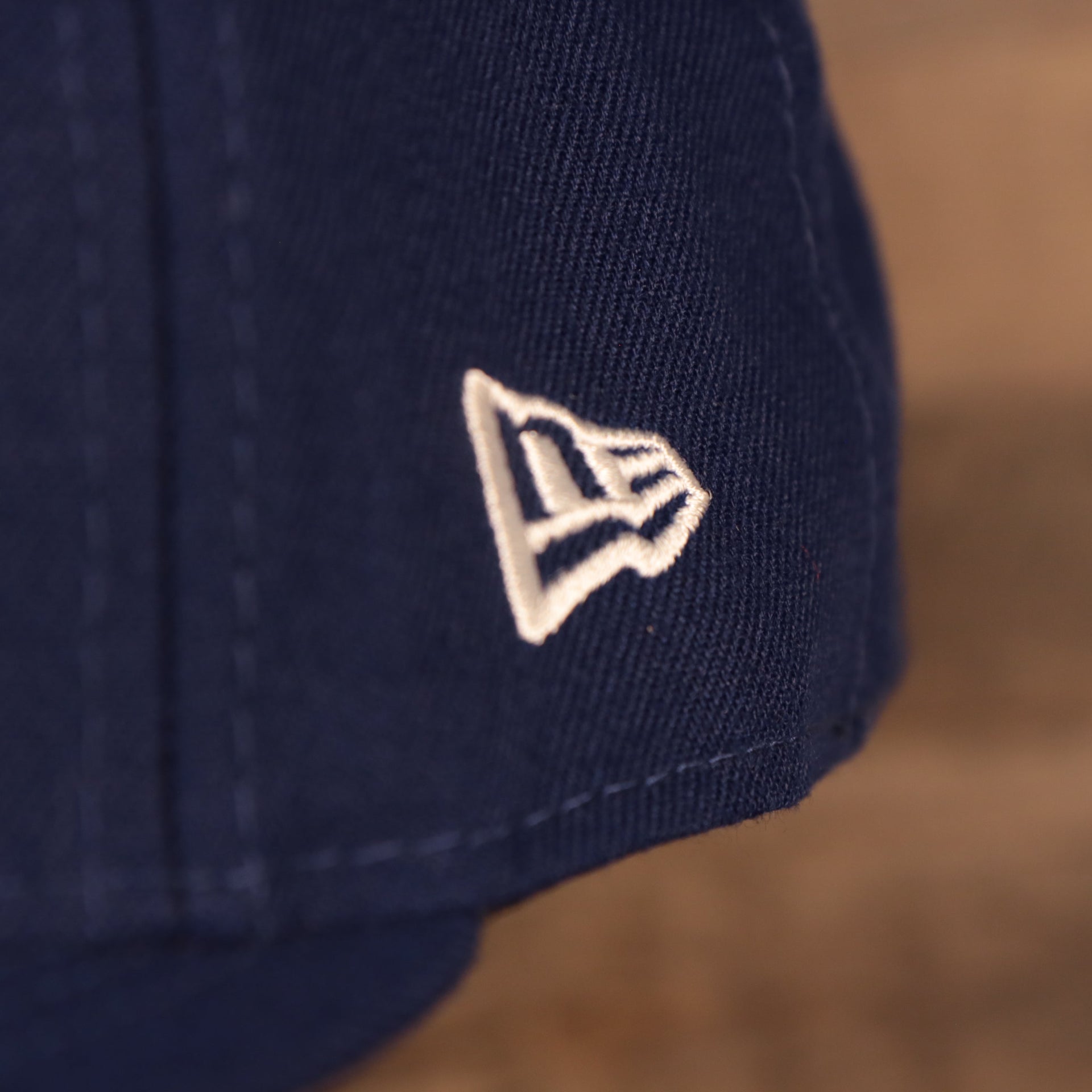 Close up of the New Era logo on the Los Angeles Dodger Multi-Color Paisley Bandana Under Brim 59Fifty Fitted Cap