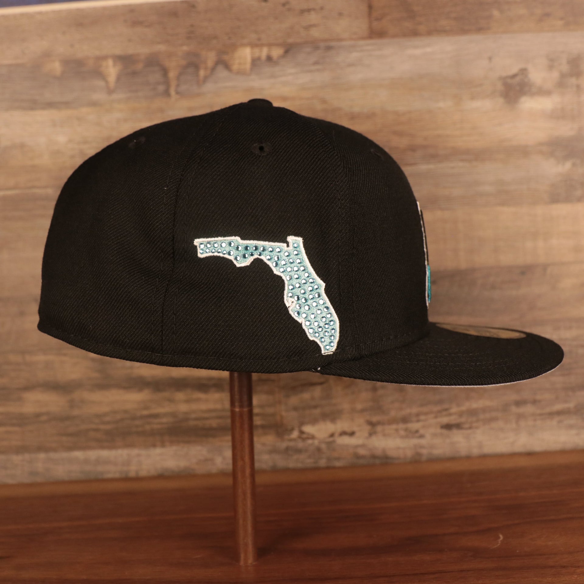 Wearer's right of the Florida Marlins Retro Cooperstown Iced Out Side Patch Orange Florida Gray Bottom 59Fifty Fitted Cap