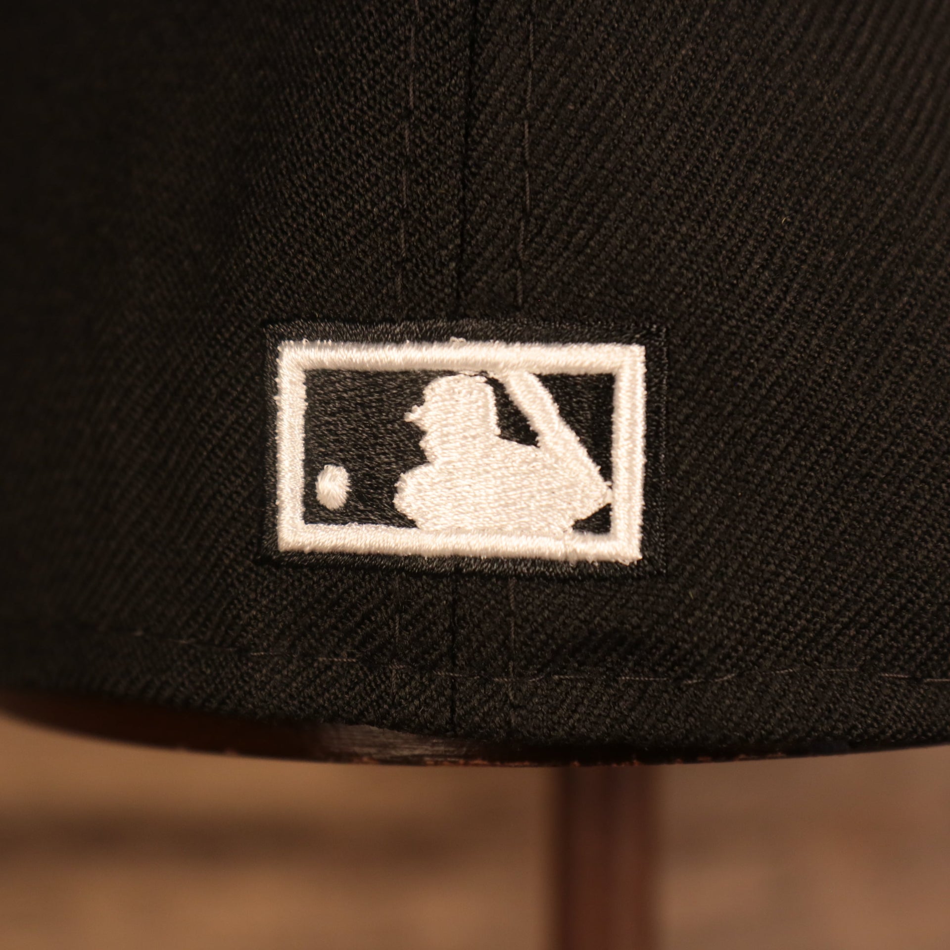 Close up of the MLB Batterman logo on the Florida Marlins Retro Cooperstown Iced Out Side Patch Orange Florida Gray Bottom 59Fifty Fitted Cap