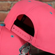 pink adjustable snap on the Lehigh Valley Ironpigs Coqui Copa De La Diversion 2023 Two-Tone Black Bottom 9Fifty Snapback Hat | Pink/Blue 950