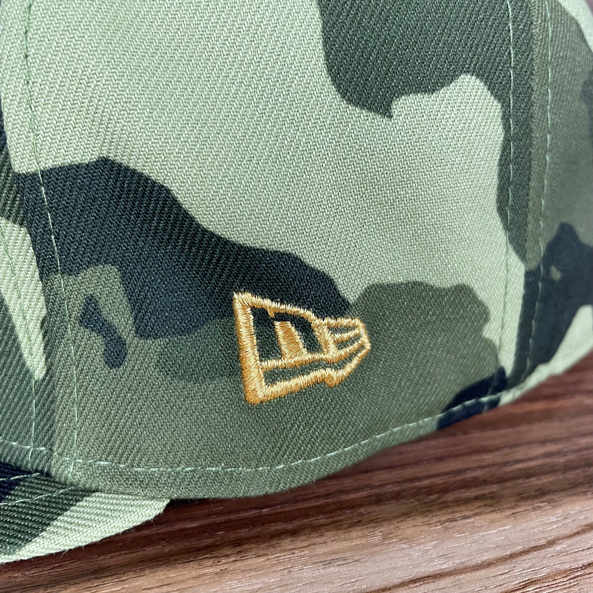 A close up of the new era logo on the Philadelphia Phillies 2022 Armed Forces Day / Memorial Day Side Patch 59Fifty Fitted Cap