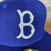 A close up of the Dodgers logo on the Brooklyn Dodgers Cooperstown 5950 Day Side Patch Green Bottom 59Fifty Fitted Cap