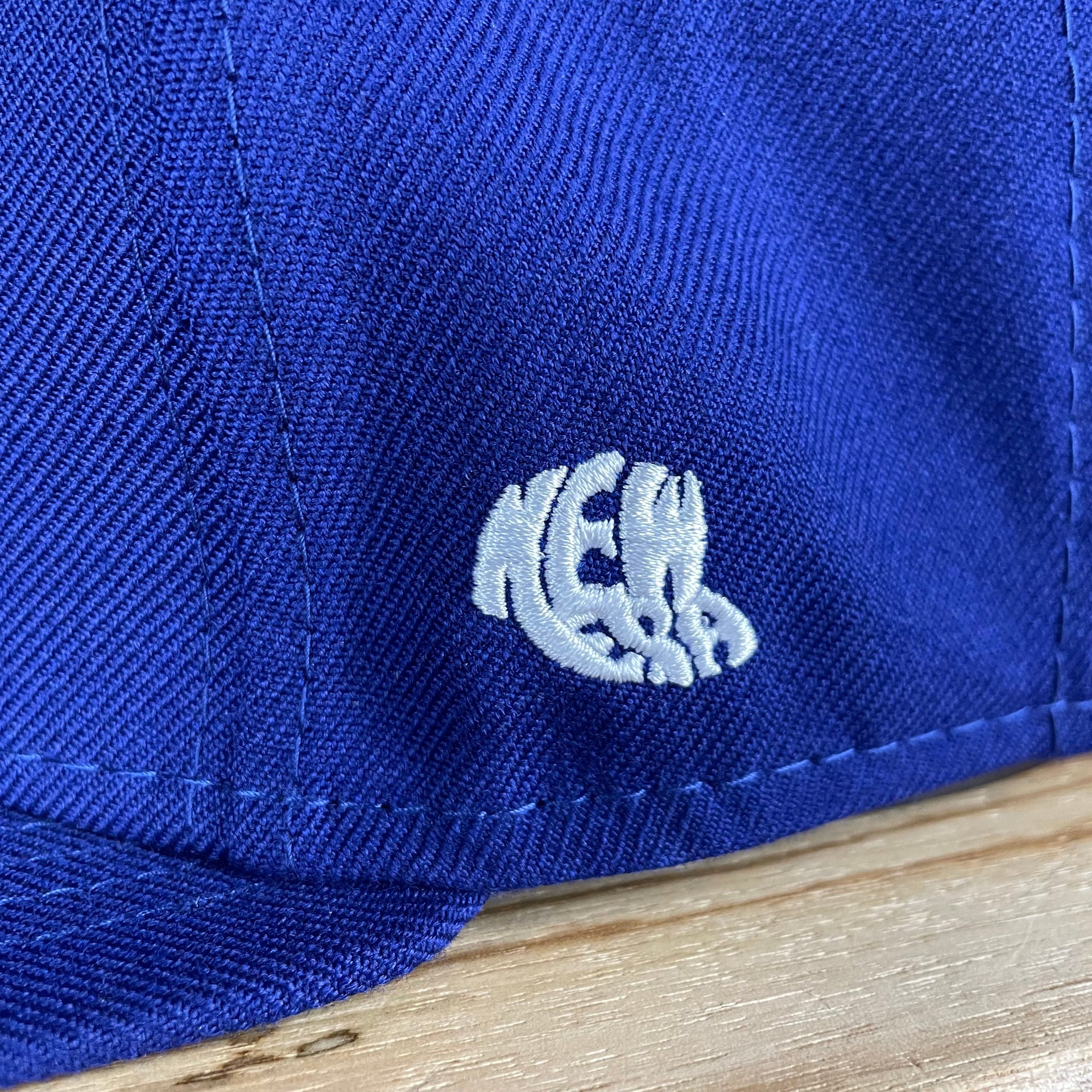A close up of the 1960s New Era logo on the Brooklyn Dodgers Cooperstown 5950 Day Side Patch Green Bottom 59Fifty Fitted Cap