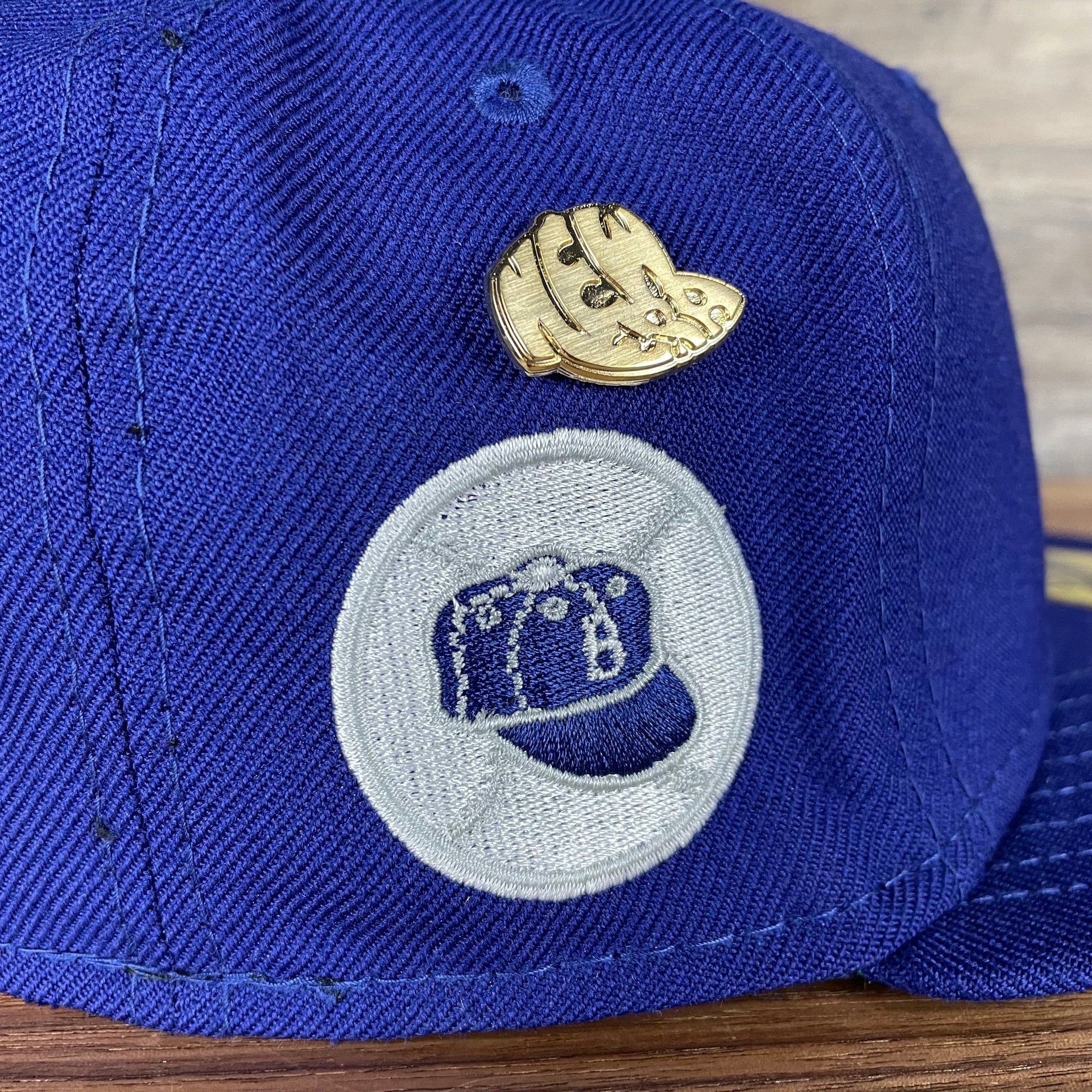 A close up of the side patch on enamel pin on the Brooklyn Dodgers Cooperstown 5950 Day Side Patch Green Bottom 59Fifty Fitted Cap