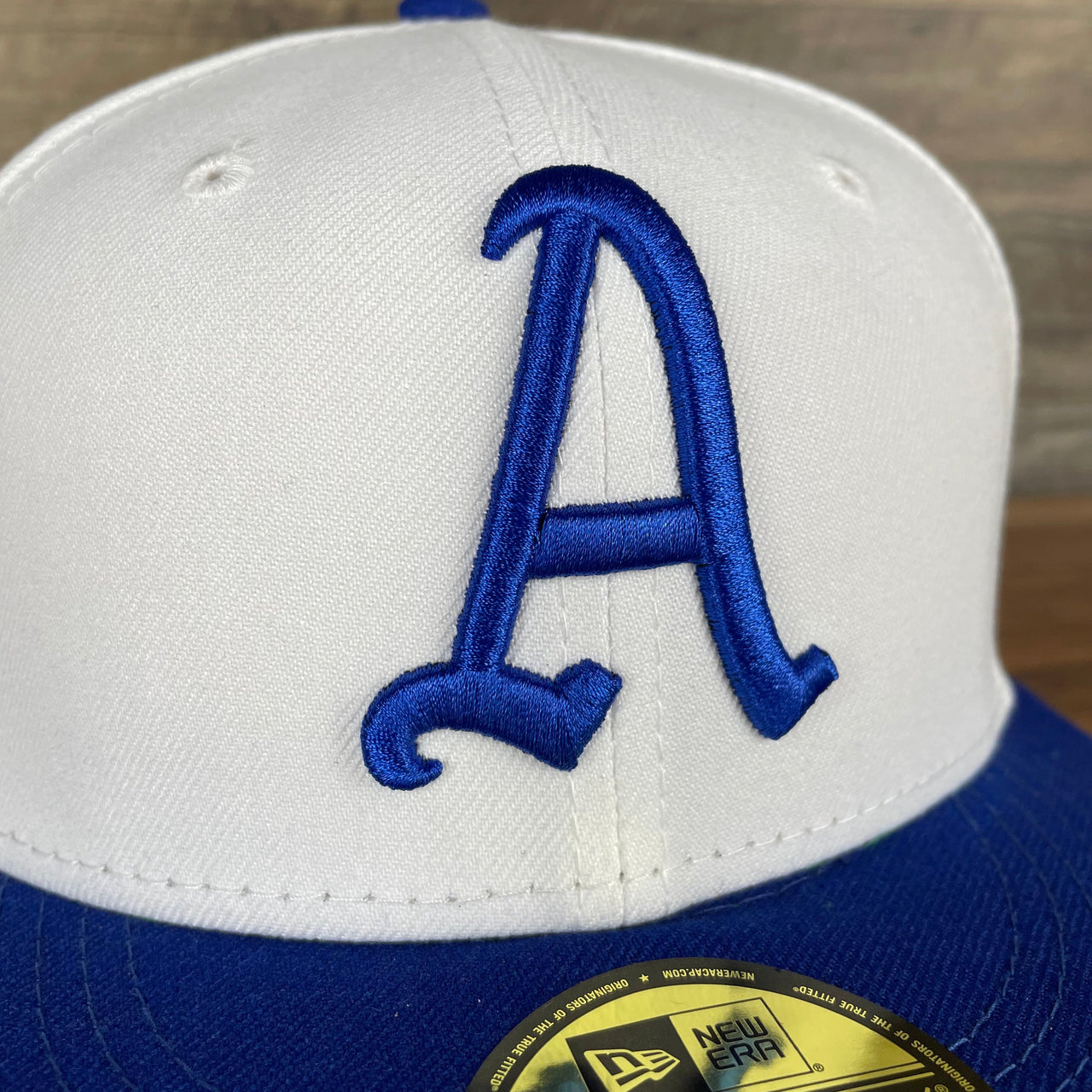 A close up of the Athletics logo on the Philadelphia Athletics Cooperstown 5950 Day Side Patch Green Bottom 59Fifty Fitted Cap