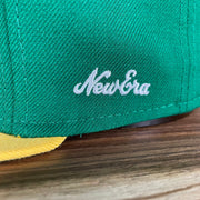 A close up of the 1970s New Era logo on the Oakland Athletics Cooperstown 5950 Day Side Patch Green Bottom 59Fifty Fitted Cap