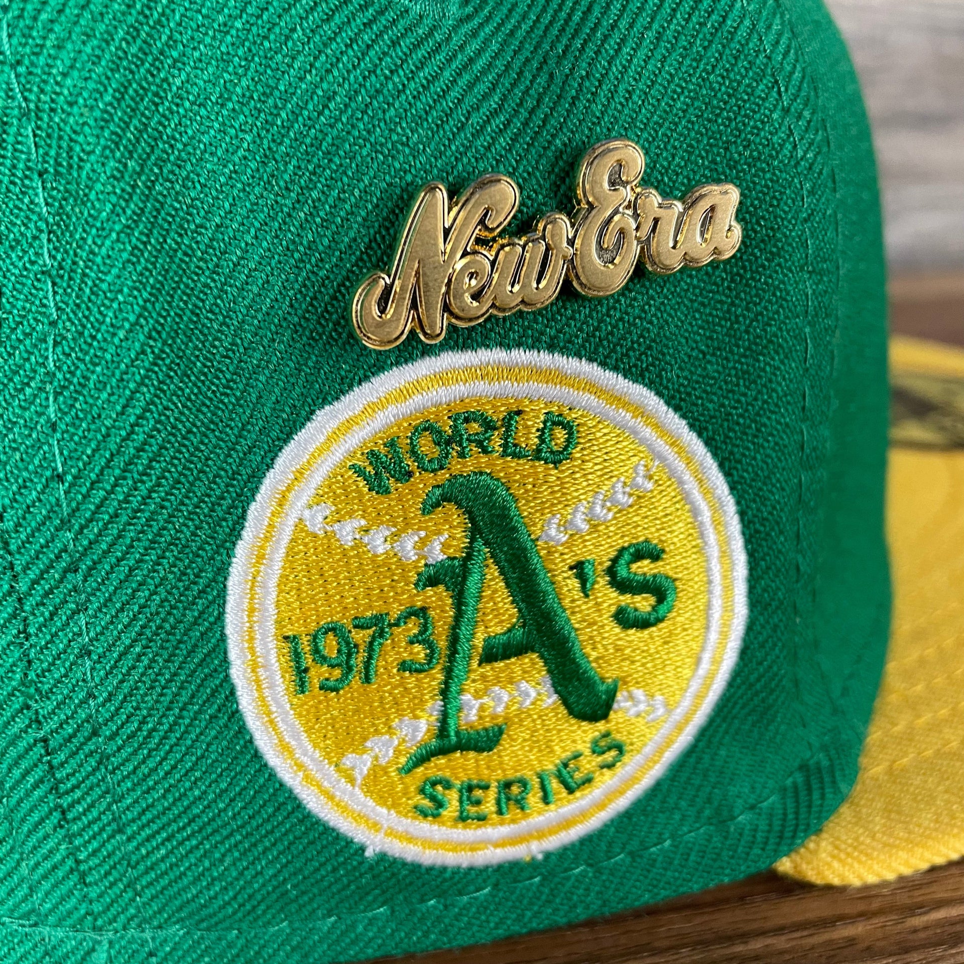 A close up of the side patch and the enamel pin on the Oakland Athletics Cooperstown 5950 Day Side Patch Green Bottom 59Fifty Fitted Cap