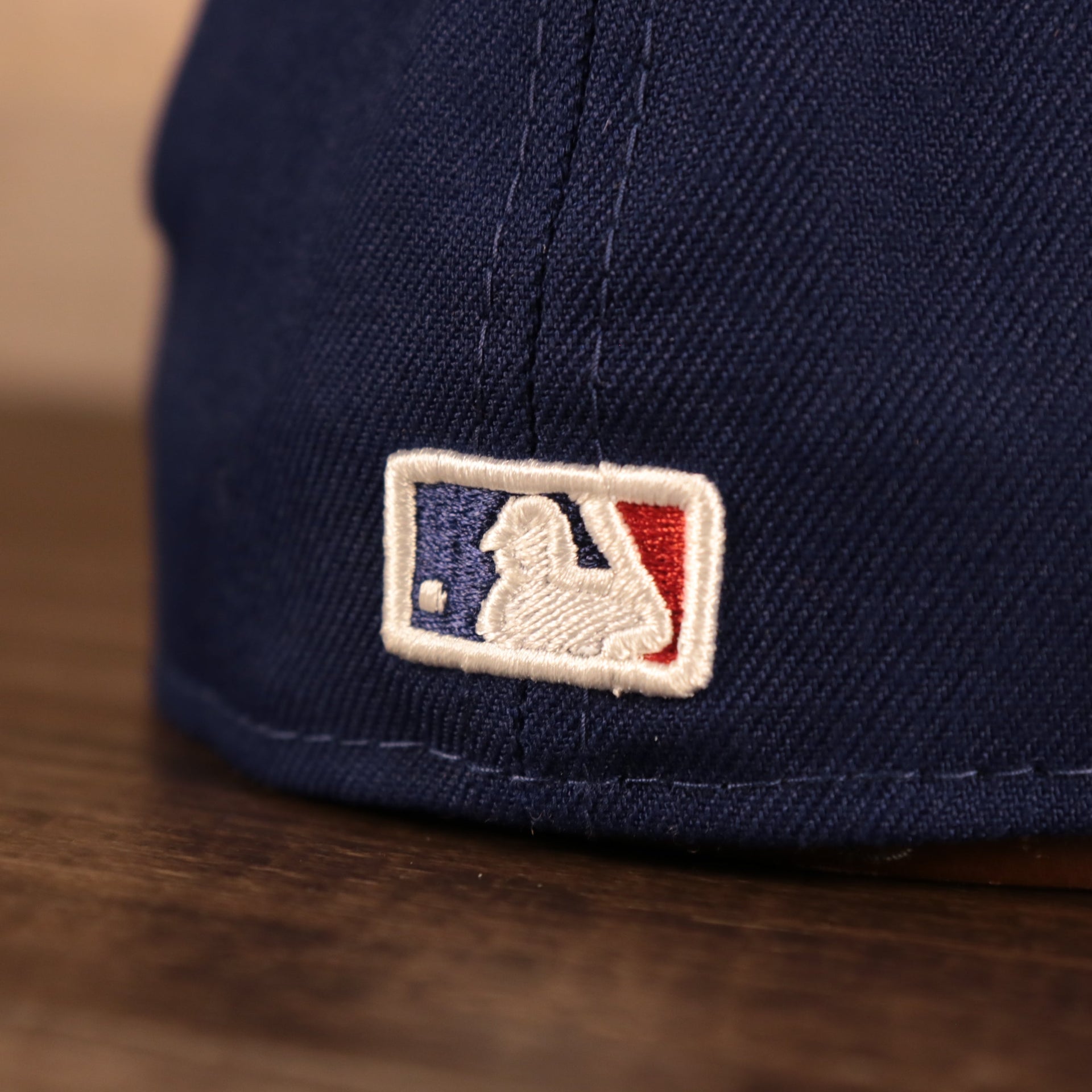 Close up of the MLB Batterman logo on the back of the Los Angeles Dodger Multi-Color Paisley Bandana Under Brim 59Fifty Fitted Cap
