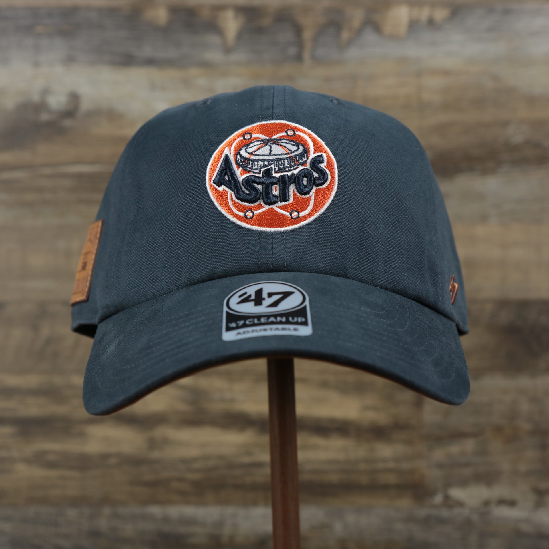 The front of the Cooperstown Houston Astros Cooperstown Collection Side Patch Leather Brown Undervisor Dad Hat | Vintage Navy Dad Hat