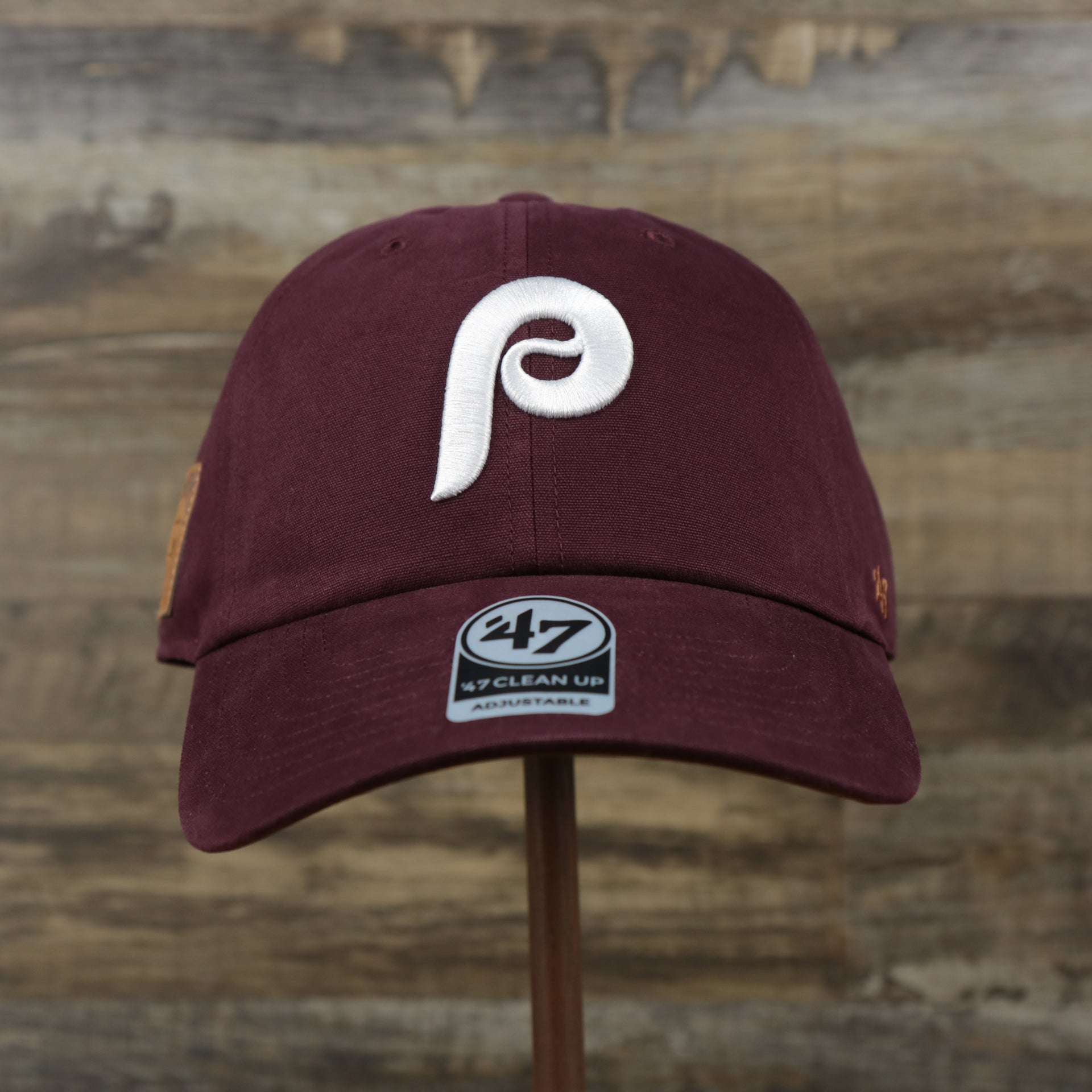 The front of the Cooperstown Philadelphia Phillies Cooperstown Collection Side Patch Leather Brown Undervisor Dad Hat | Maroon Dad Hat
