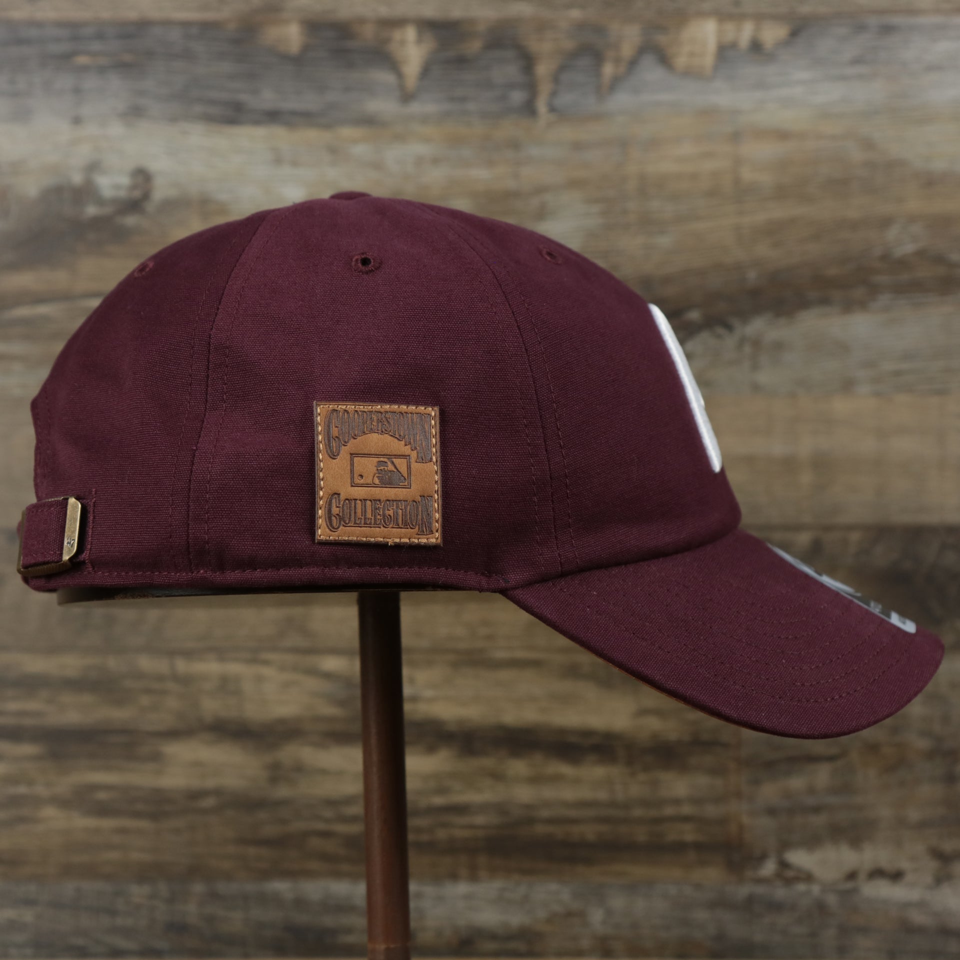 The wearer's right on the Cooperstown Philadelphia Phillies Cooperstown Collection Side Patch Leather Brown Undervisor Dad Hat | Maroon Dad Hat