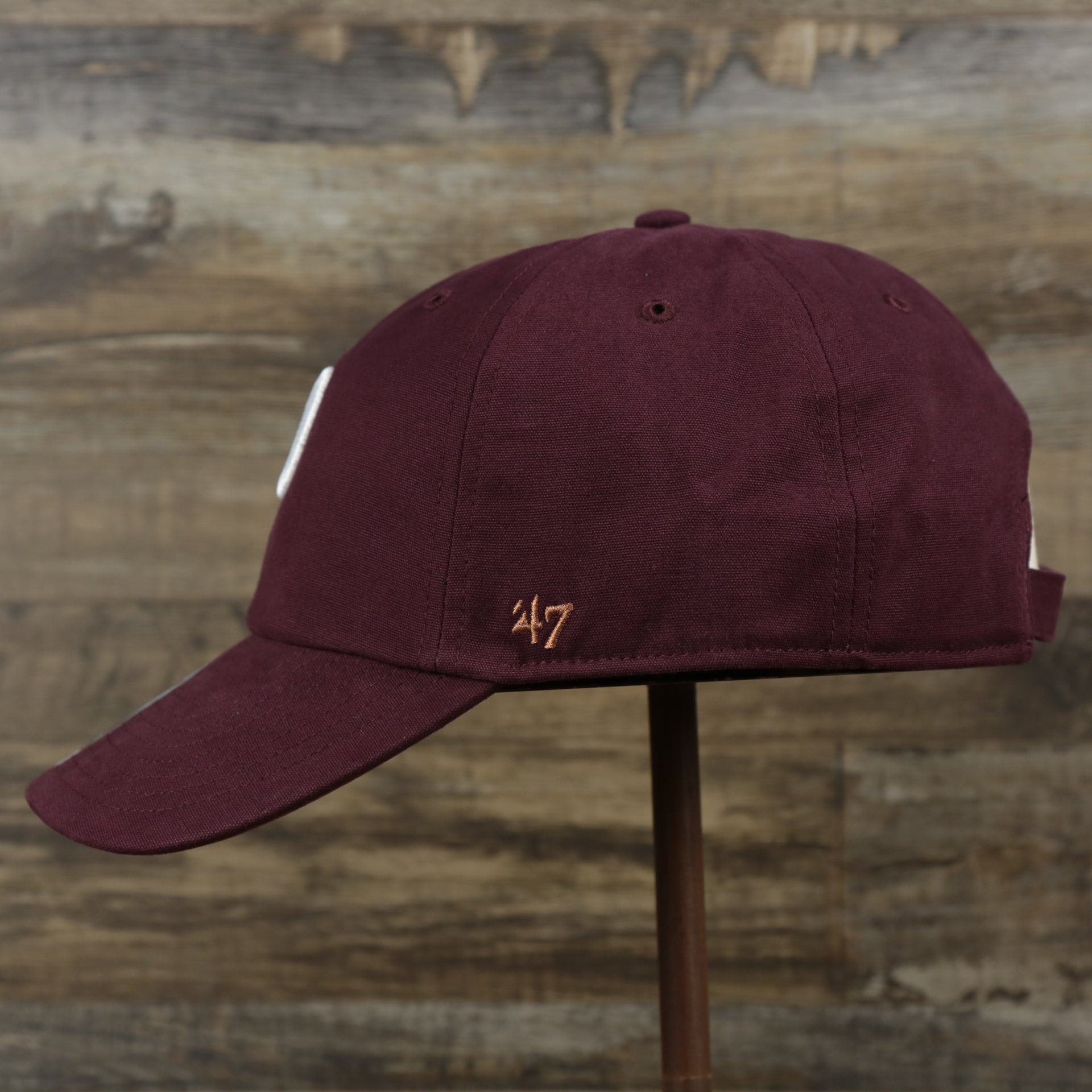 The wearer's left on the Cooperstown Philadelphia Phillies Cooperstown Collection Side Patch Leather Brown Undervisor Dad Hat | Maroon Dad Hat