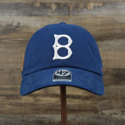 The front of the Cooperstown Brooklyn Dodgers Cooperstown Collection Side Patch Leather Brown Undervisor Dad Hat | Vintage Royal Blue Dad Hat