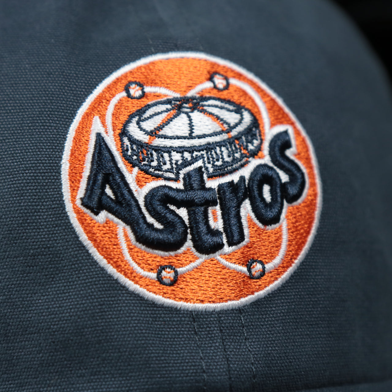 The Astros Logo on the Cooperstown Houston Astros Cooperstown Collection Side Patch Leather Brown Undervisor Dad Hat | Vintage Navy Dad Hat